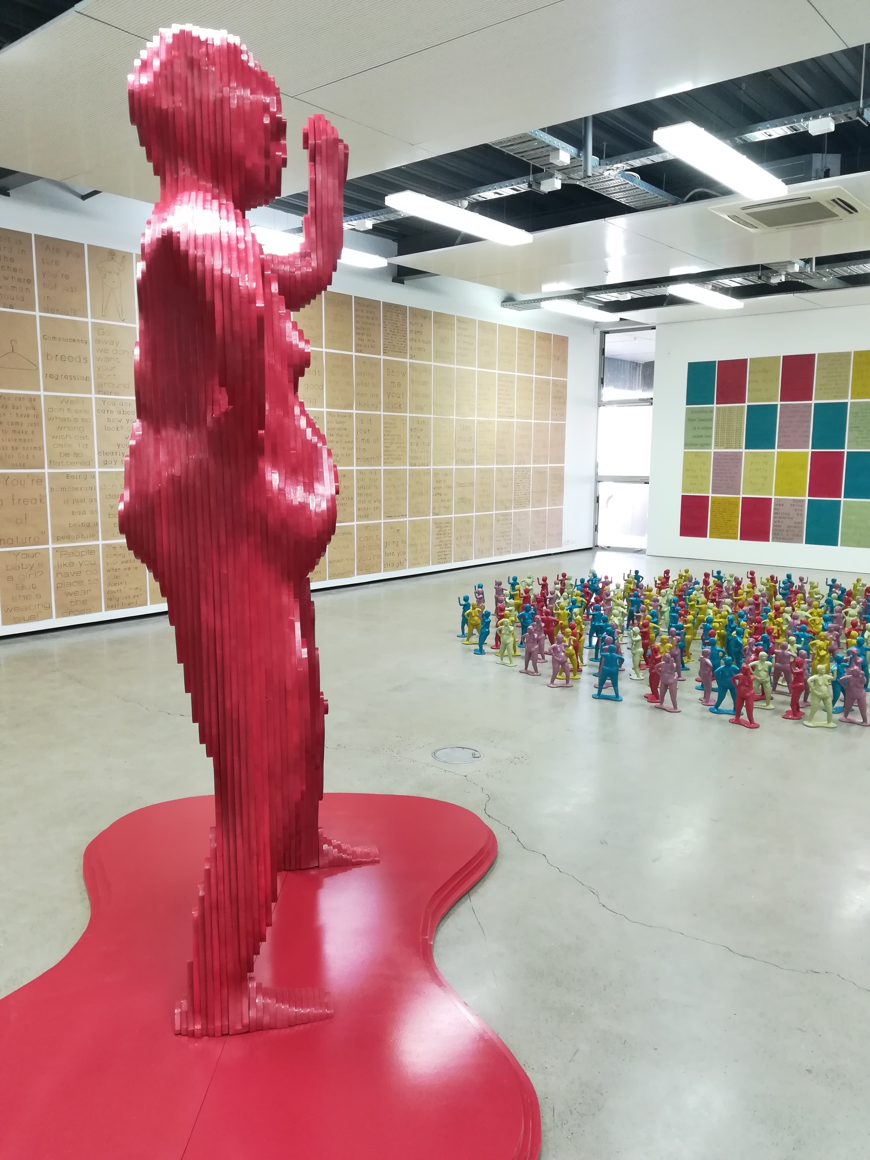 Installation photo of multi-coloured ceramic berthas, 3m tall Bertha & 300 wall posters