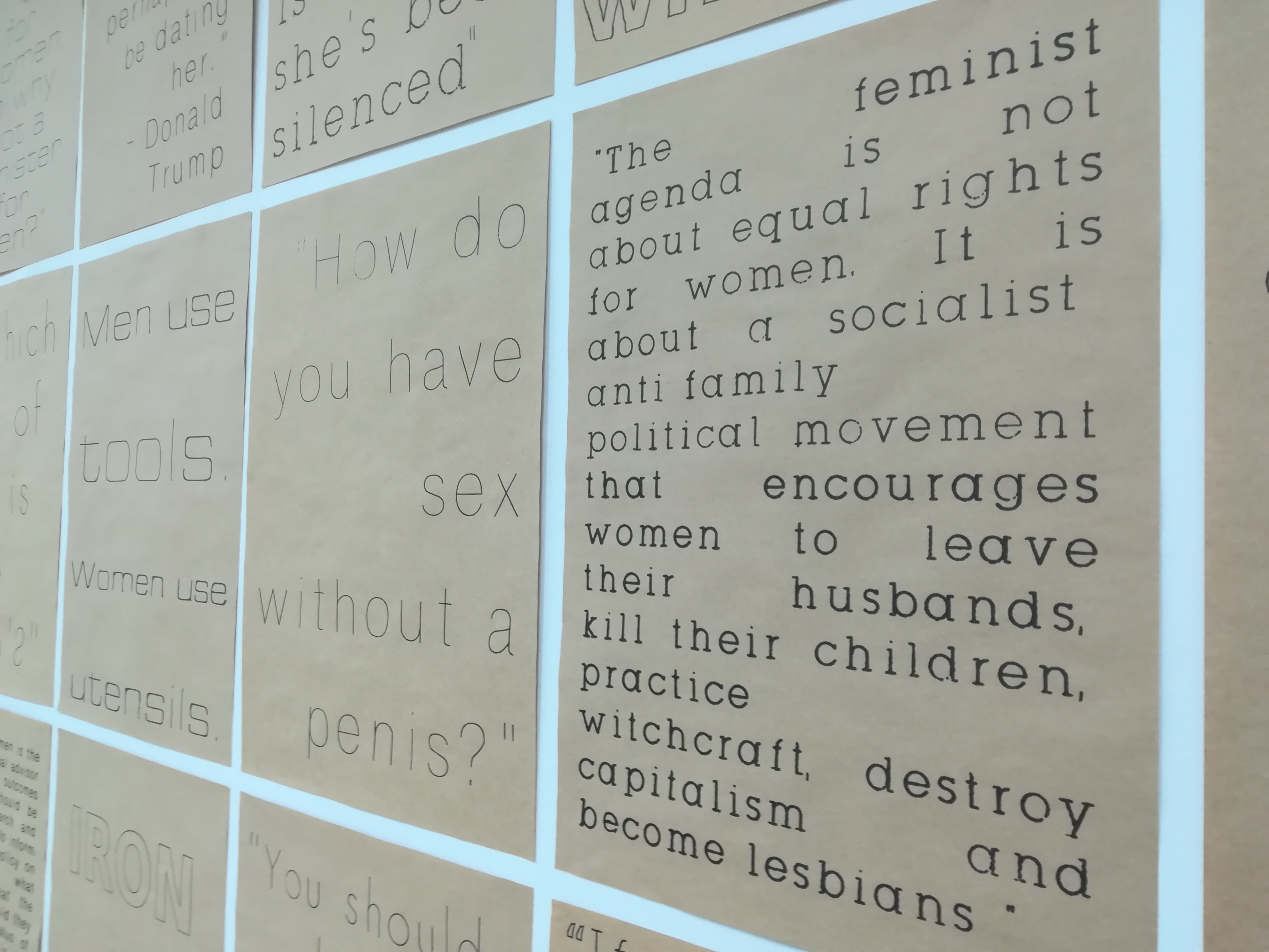 Photo of gallery wall displaying feminist posters